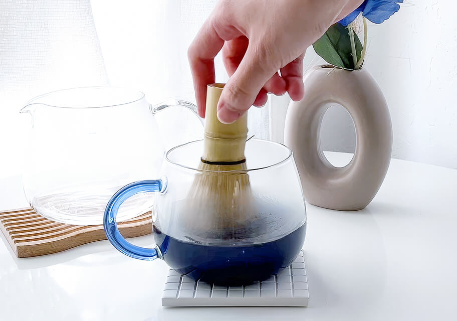 Whisking blue matcha